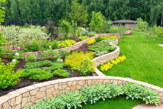 Beautifully landscaped tiered garden with stone walls and colourful plants