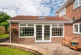 Professionally installed block paving patio and garden landscaping with a brick boundary wall in Kent.