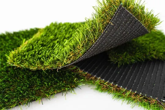 Artificial grass rolls displaying the turf and backing