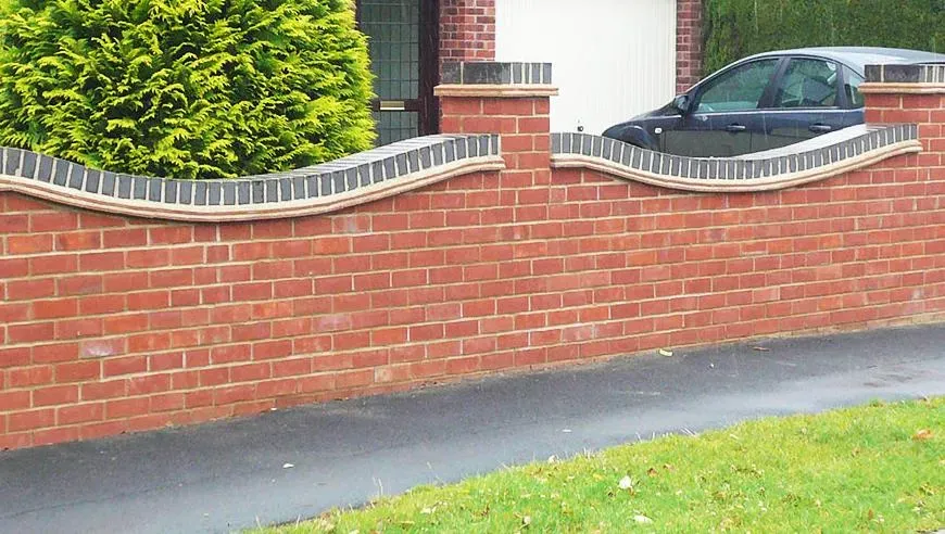 Decorative brick garden wall with wavy coping
